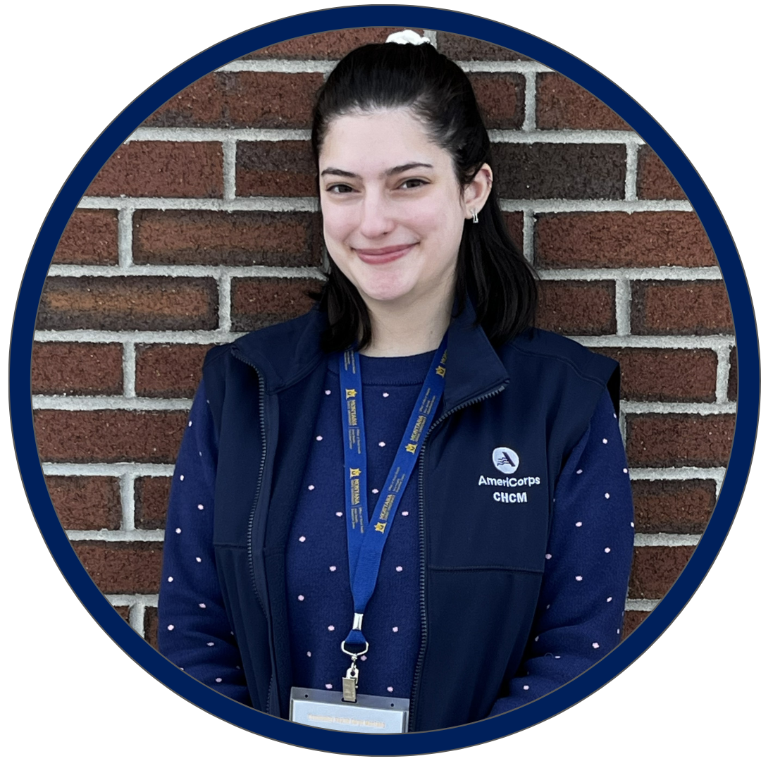 headshot of CHCM member Ruby standing in front of brick wall