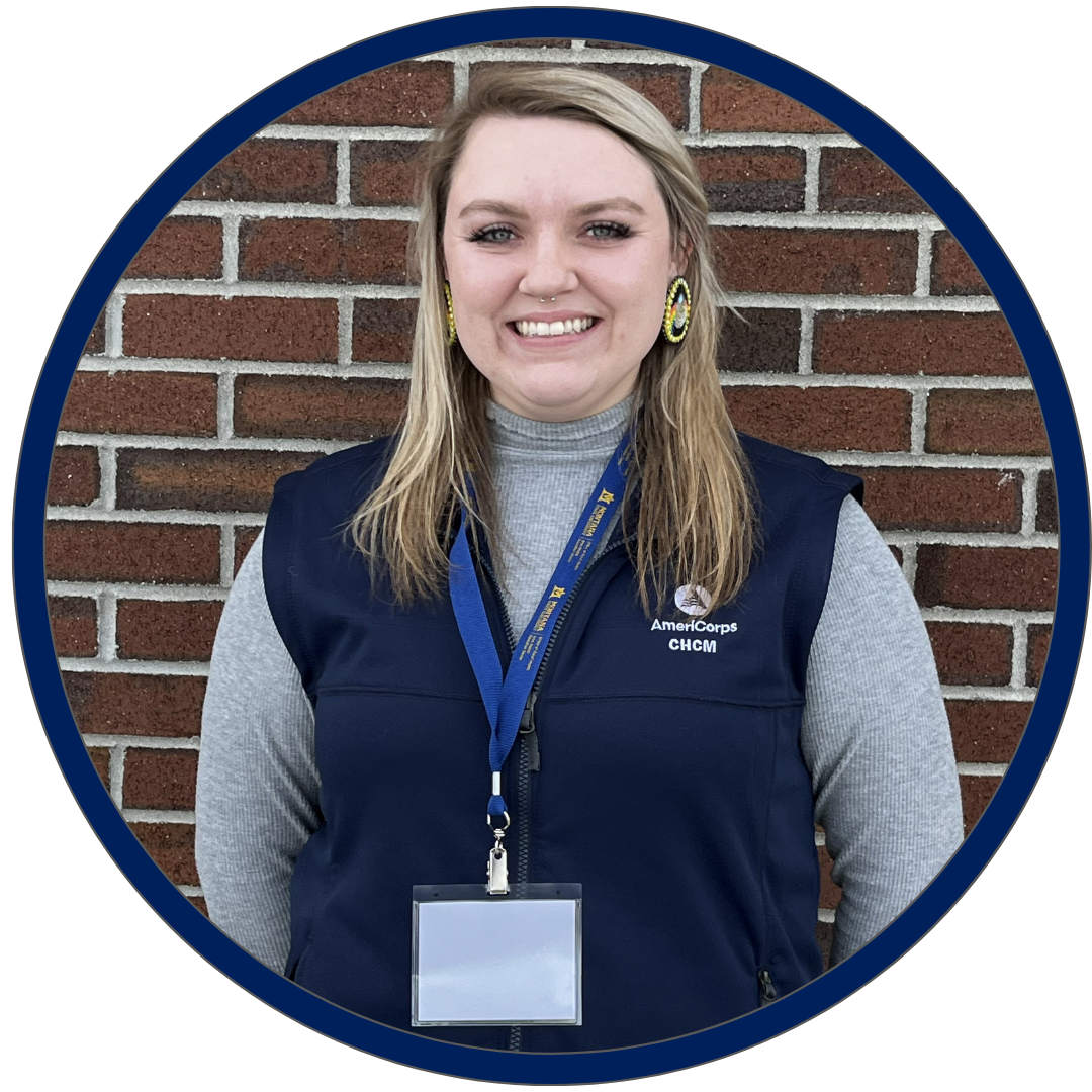 headshot of CHCM member Sammie standing in front of brick wall